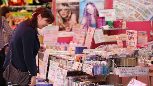 A woman looks at cosmetics at Ameyoko market in Tokyo, Japan. The government revised annualized GDP growth for January-March to 4.1 percent from an earlier reading of 3.5 percent on Monday.